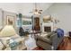 Inviting living room features hardwood floors, fireplace, and large windows overlooking the yard at 405 Forest Valley Road, Sandy Springs, GA 30342