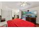 Inviting bedroom features a red comforter, sliding glass door, and a vanity with dark wood at 405 Forest Valley Road, Sandy Springs, GA 30342