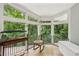 Bright sunroom with large windows offering lush forest views and natural light at 405 Forest Valley Road, Sandy Springs, GA 30342