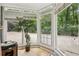 Cozy sunroom offering natural light with large windows and views of the outdoor yard at 405 Forest Valley Road, Sandy Springs, GA 30342