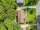 Aerial view of a home with a well-manicured lawn, mature trees and a red stained deck at 621 Windgrove Se Rd, Marietta, GA 30067