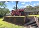 Back of house showcasing upper-level deck, stairs, brick steps, and retaining wall at 621 Windgrove Se Rd, Marietta, GA 30067