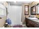 Bathroom with a tub and shower combination, framed artwork, and a decorative vanity at 621 Windgrove Se Rd, Marietta, GA 30067