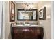 Bathroom showcasing a double vanity, granite countertop, ornate mirror, and neutral decor at 621 Windgrove Se Rd, Marietta, GA 30067