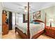 Comfortable bedroom with a four-poster bed, hardwood floors, and natural light at 621 Windgrove Se Rd, Marietta, GA 30067