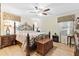 Cozy bedroom with hardwood floors, ceiling fan, decorative curtains, and a wrought iron bed frame at 621 Windgrove Se Rd, Marietta, GA 30067