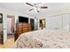 Bedroom featuring a floral comforter, ceiling fan, and ample closet space at 621 Windgrove Se Rd, Marietta, GA 30067