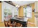 Bright dining area featuring window views and pot rack at 621 Windgrove Se Rd, Marietta, GA 30067