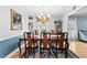 Formal dining room with chandelier, built-in shelving, and seating for eight at 621 Windgrove Se Rd, Marietta, GA 30067