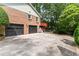 Brick home showcasing an attached two-car garage and an upper-level deck offering scenic views at 621 Windgrove Se Rd, Marietta, GA 30067