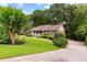 Lovely front yard, a lush green lawn, mature trees, and an inviting home at 621 Windgrove Se Rd, Marietta, GA 30067