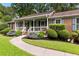 Charming home featuring a covered front porch and well-maintained landscaping at 621 Windgrove Se Rd, Marietta, GA 30067