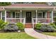 Inviting front porch with columns, green shutters, and brick steps at 621 Windgrove Se Rd, Marietta, GA 30067