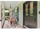 Covered front porch with tile flooring, seating, and stylish lighting at 621 Windgrove Se Rd, Marietta, GA 30067