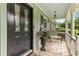 Welcoming front porch with black stained front door, an American flag, and room to sit at 621 Windgrove Se Rd, Marietta, GA 30067