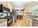 Open kitchen featuring granite countertops, stainless steel appliances, and window view to the backyard at 621 Windgrove Se Rd, Marietta, GA 30067