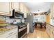 Charming kitchen with stainless steel appliances, granite countertops, and adjacent dining area at 621 Windgrove Se Rd, Marietta, GA 30067
