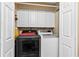 Convenient laundry area with modern front-load washer and dryer and ample storage cabinets above at 621 Windgrove Se Rd, Marietta, GA 30067