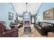 Comfortable living room with vaulted ceiling, ceiling fan, brick fireplace, and leather furniture at 621 Windgrove Se Rd, Marietta, GA 30067