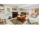 Inviting living room features a fireplace, tile flooring, comfortable seating, and natural light at 621 Windgrove Se Rd, Marietta, GA 30067