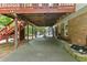 View of the covered patio beneath a deck, featuring concrete flooring and access to the backyard at 621 Windgrove Se Rd, Marietta, GA 30067