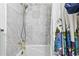 Close-up of modern shower with marble tile, rainfall shower head, and floral shower curtain at 621 Windgrove Se Rd, Marietta, GA 30067