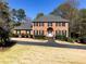 Traditional two-story brick home with black shutters and a well-manicured front lawn at 938 Lost Valley Se Dr, Conyers, GA 30094
