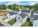 Street view of new homes with garages and sidewalks, near intersection with plenty of trees at 1294 Six Sisters St, Dacula, GA 30019