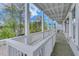 Expansive balcony boasts classic white railings and peaceful views of the surrounding trees at 1294 Six Sisters St, Dacula, GA 30019