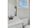 This bathroom features a vanity, mirror, window, and toilet at 1294 Six Sisters St, Dacula, GA 30019