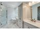Bright bathroom featuring a glass enclosed shower, soaking tub, vanity, and marble flooring at 1294 Six Sisters St, Dacula, GA 30019
