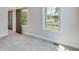 This bedroom features carpet floors, trim, a door to the balcony, and a large window overlooking the exterior at 1294 Six Sisters St, Dacula, GA 30019
