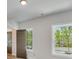 Bedroom featuring white walls, two windows offering natural light, and interior door at 1294 Six Sisters St, Dacula, GA 30019