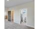Bedroom featuring gray walls, neutral carpet, walk-in closet, and ensuite bathroom with a toilet at 1294 Six Sisters St, Dacula, GA 30019