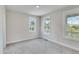 Cozy bedroom with neutral walls and carpet, complemented by natural light from multiple windows at 1294 Six Sisters St, Dacula, GA 30019