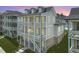 View of three story home featuring double balconies and brick accents on the ground level at 1294 Six Sisters St, Dacula, GA 30019