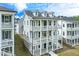 Charming three-story home with multiple balconies and light gray siding offers a welcoming curb appeal at 1294 Six Sisters St, Dacula, GA 30019