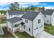 View of the garage and home with a side porch, offering privacy and charming curb appeal at 1294 Six Sisters St, Dacula, GA 30019