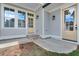 Classic gray home's front porch with gray siding and cream trim at 1294 Six Sisters St, Dacula, GA 30019
