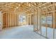 Unfinished interior showing wooden frame, plywood walls and abundant natural light at 1294 Six Sisters St, Dacula, GA 30019