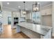 Bright kitchen features a large island with granite countertops and stainless steel appliances at 1294 Six Sisters St, Dacula, GA 30019