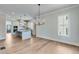 Open-concept kitchen with center island, stainless steel appliances, and hardwood floors at 1294 Six Sisters St, Dacula, GA 30019