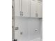 Laundry room with utility hookups and white cabinets at 1294 Six Sisters St, Dacula, GA 30019