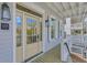 Classic covered porch features white railings, exterior lighting, and a stylish front door at 1294 Six Sisters St, Dacula, GA 30019