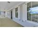 This covered porch features wooden floors, windows, and white railing with views of the outside at 1294 Six Sisters St, Dacula, GA 30019