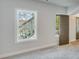 This room has carpet floors, trim, a door to the balcony, and a large window overlooking the exterior at 1294 Six Sisters St, Dacula, GA 30019