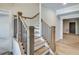 This interior staircase features wooden stairs, white risers, and wooden handrails with black wrought iron at 1294 Six Sisters St, Dacula, GA 30019