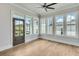 Bright sunroom with many windows and hardwood flooring at 1294 Six Sisters St, Dacula, GA 30019