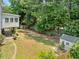 Large backyard with mature trees, shed, and deck offers a private outdoor oasis at 1975 Fairway Close Ter, Lawrenceville, GA 30043