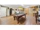 Finished basement with pool table, hardwood floors, and custom wood accent wall for entertainment at 1975 Fairway Close Ter, Lawrenceville, GA 30043